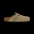 Beige suede clog shoe with a brown sole on a white background