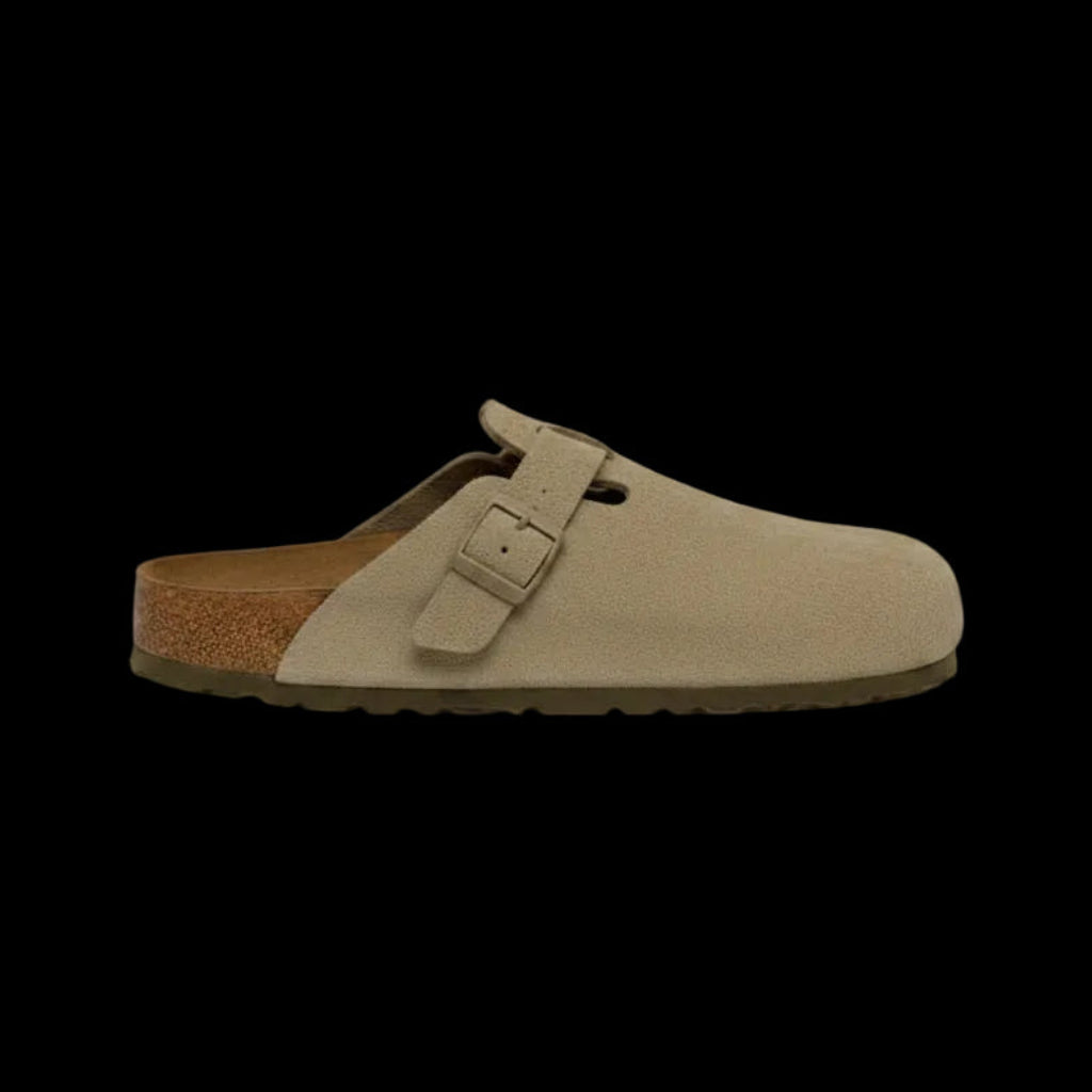 Beige suede clog shoe with a brown sole on a white background